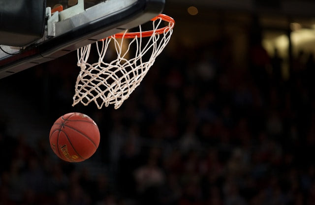 a basketball flying through a net