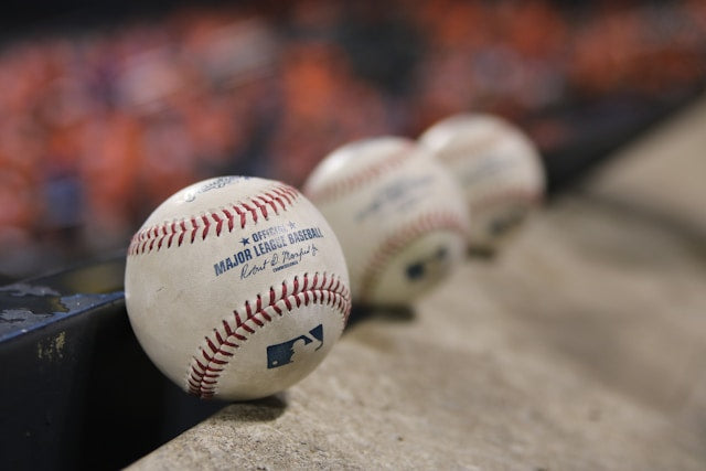 three MLB baseballs lined up 